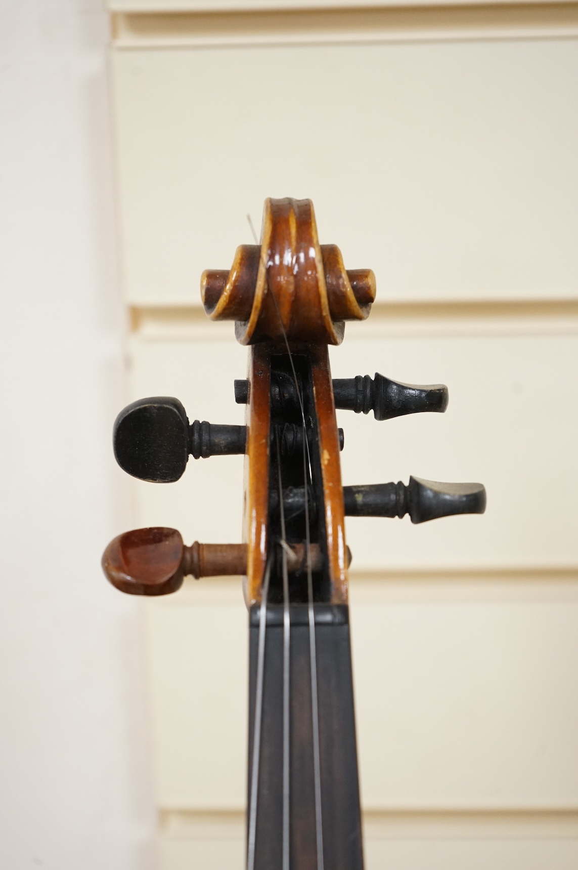 Five cased 20th century violins, including; a German violin, two Czech violins, a three-quarter size violin with a label for Bienfait, and a Romanian quarter size violin, all in cases or the remains of cases.